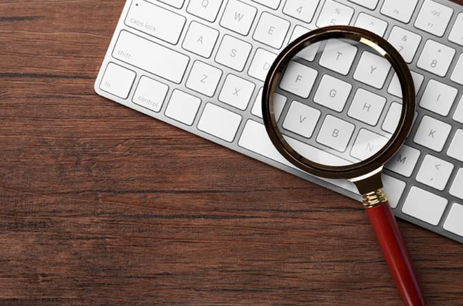 Magnifying glass over the top of a keyboard