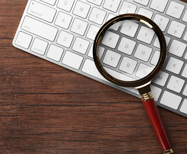 Magnifying glass over the top of a keyboard